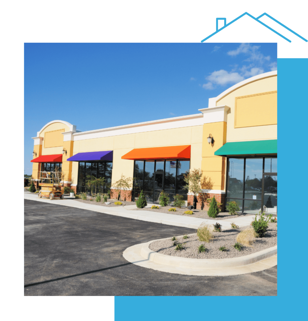 A row of stores with colorful awnings on the side.