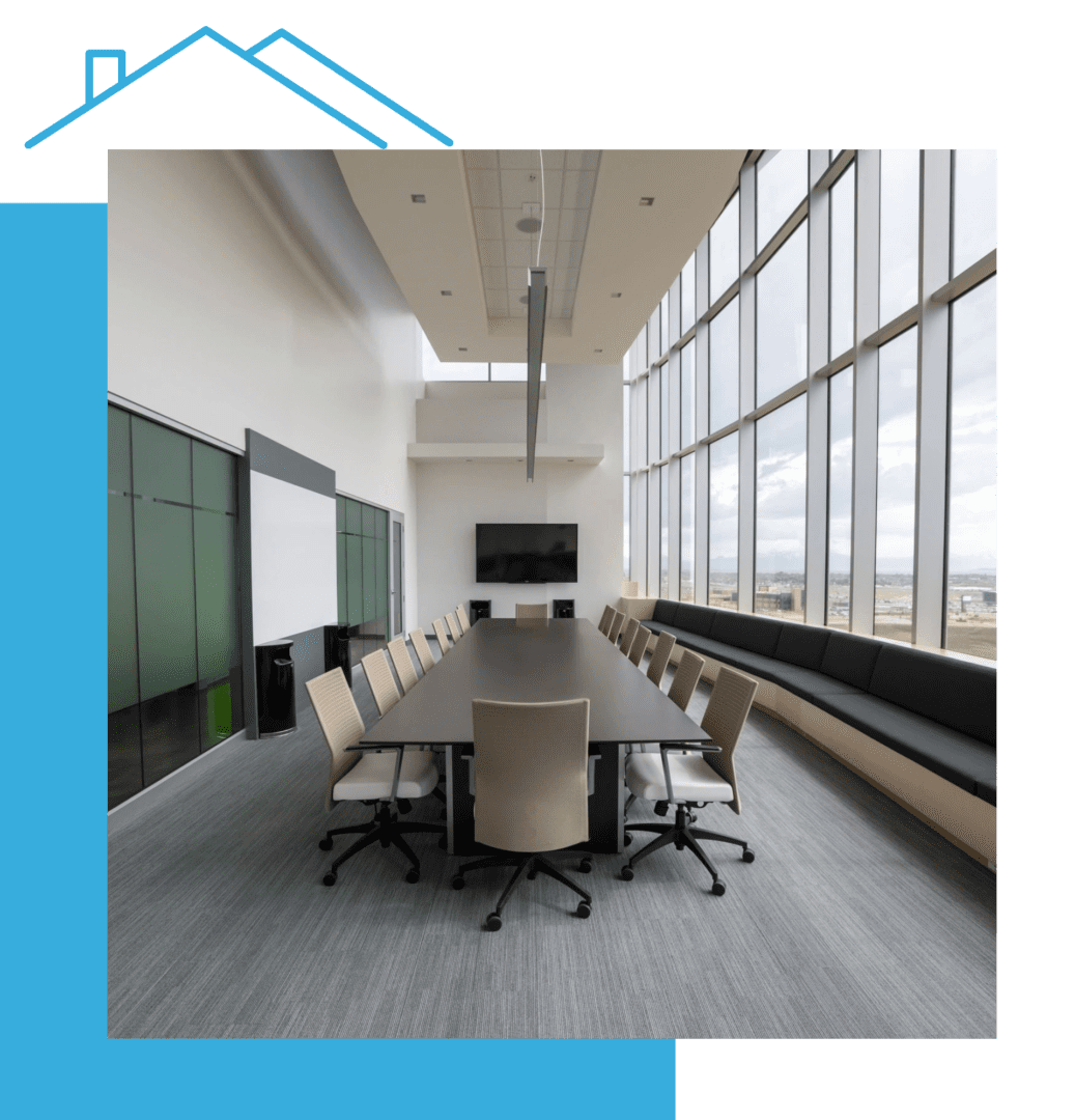 A conference room with chairs and tables in front of large windows.