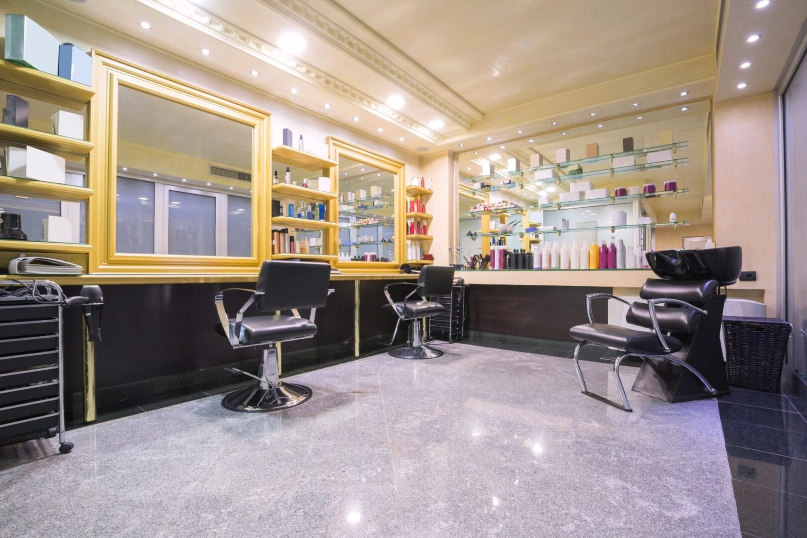 A hair salon with many chairs and shelves of products.